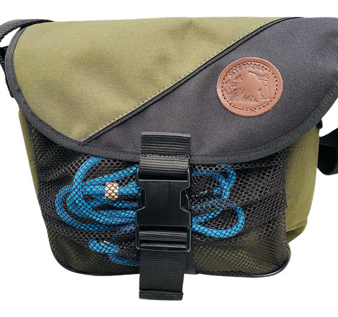 Green and black bag with a blue braid slip lead and leather patch on a white background