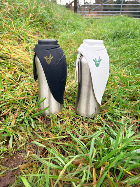 Two water bottles on grass with a brand logo.