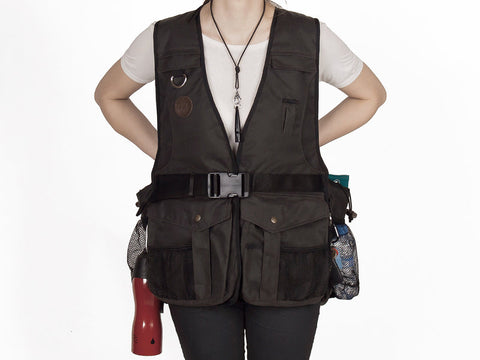 Person wearing a brown waxed gundog trainng vest with multiple pockets on a white background