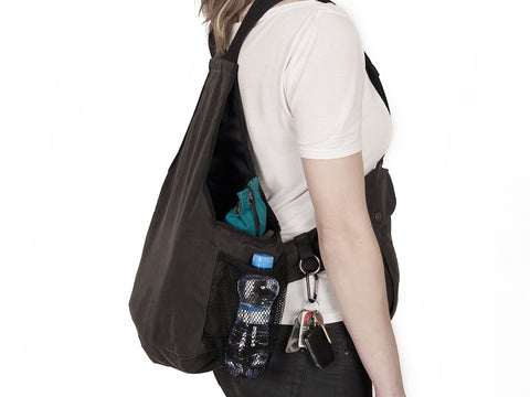 Person wearing a brown waxed training vest with items in the pocket on a white background