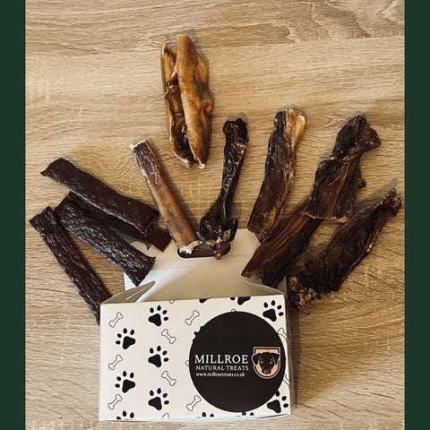 Dog treats from Millroe Natural Treats on a wooden surface
