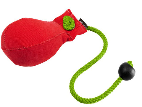 A red canvas dummy ball with a bright green braided rope and a black toggle, shown on a plain white background.
