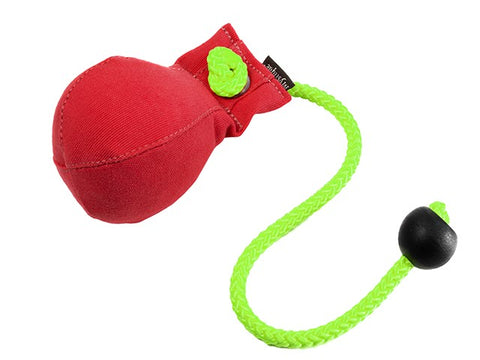 A red canvas dummy ball with a bright green braided rope and a black toggle, shown on a plain white background.