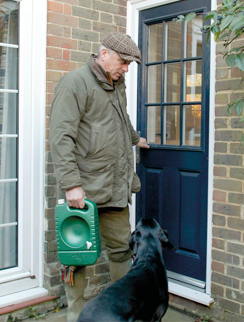 A gun dog owner carrying a portable dog water bowl sold by Muntjac